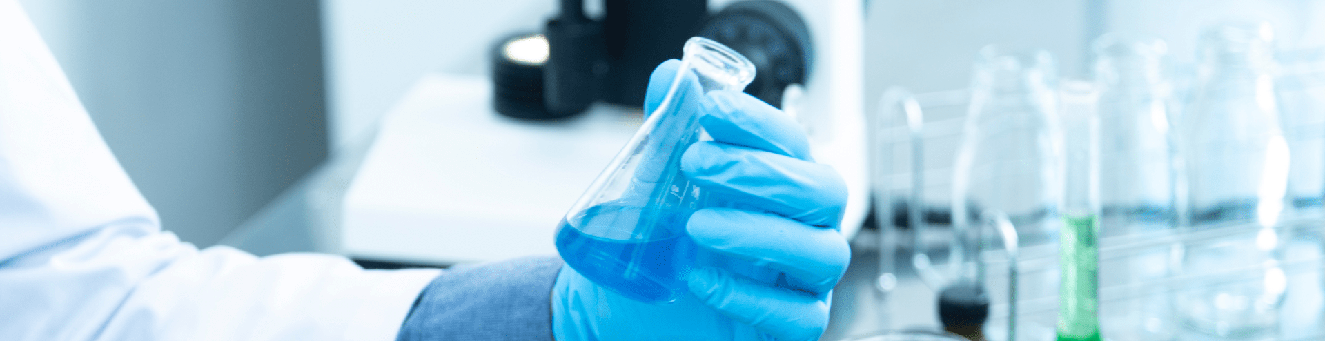 close up researcher holding glassware