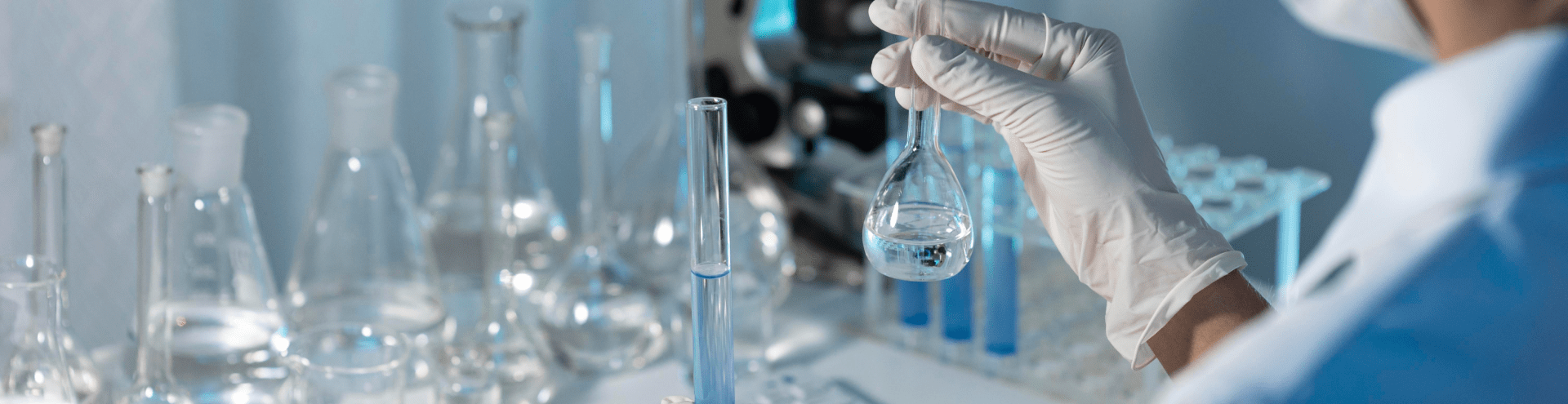 close up researcher holding glassware