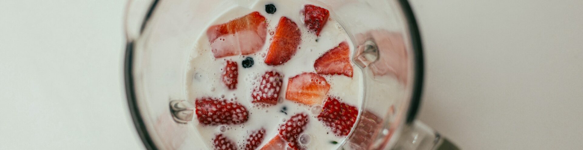 mug with strawberries and milk from above