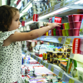 child at shop shelf