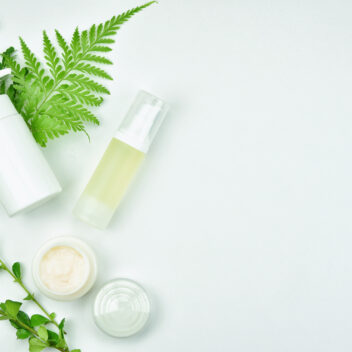 Cosmetic bottle containers with green herbal leaves